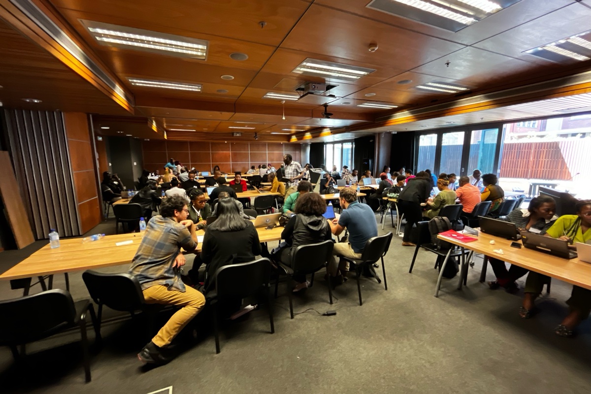 Wide view of the workshop room with participants at tables
