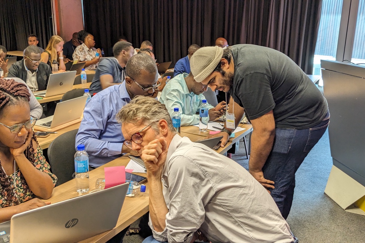 Instructor helping a participant at their laptop